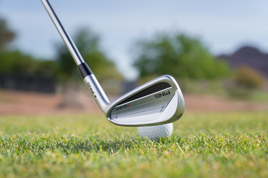 Ping i240 iron behind the ball.