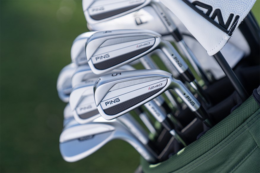 Ping i240 irons in a golf bag.