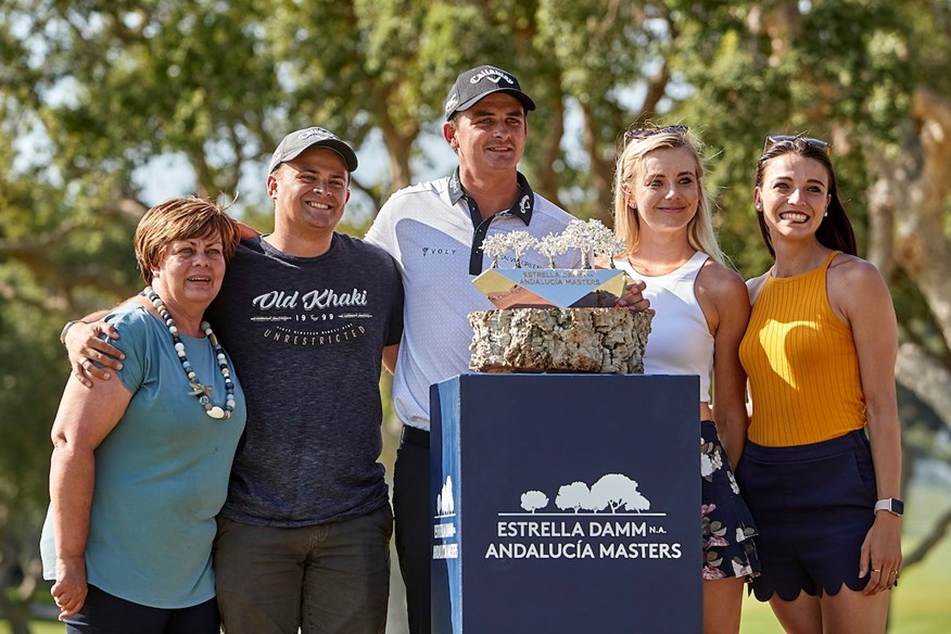 Christiaan Bezuidenhout and his family pose with his maiden DP World Tour trophy at the 2019 Andalucia Masters.