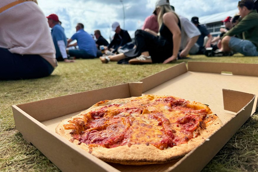 Enjoying pizza in the spectator village at The Open