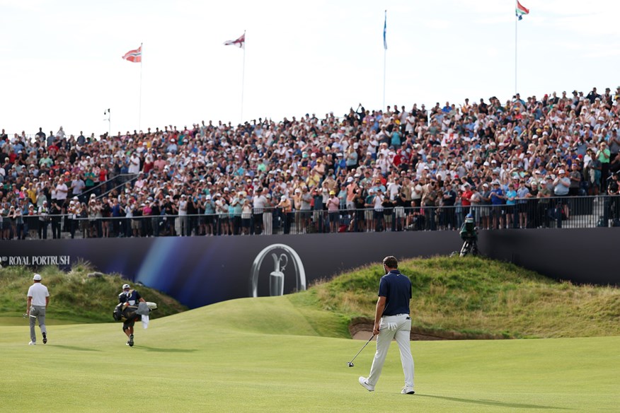 The crowd are on their feet as Scottie Scheffler makes the iconic walk up the 72nd hole at the Royal Portrush.