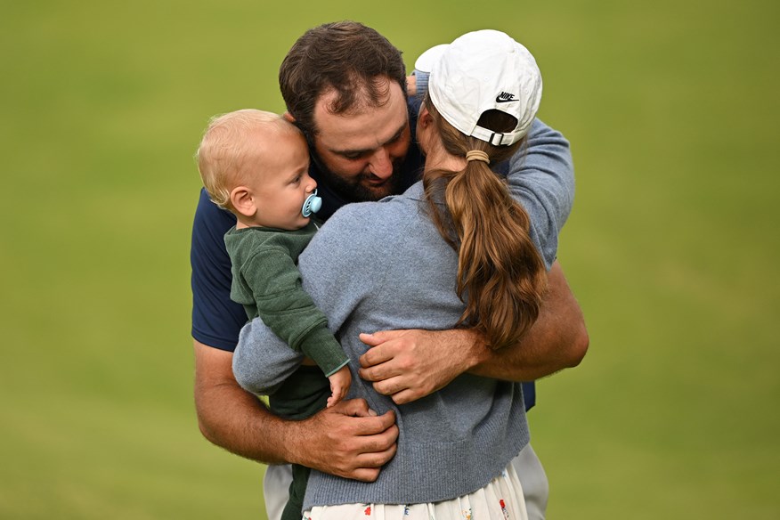 Scottie Scheffler embraces his wife and son after winning The Open.