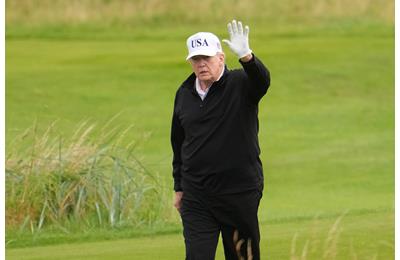 President Donald Trump waves to the media as he plays golf at Turnberry during his visit in July 2025.