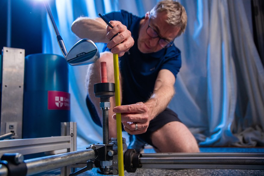 Dr. Jonathan Roberts sets up a wedge shot for the golf balls robot test.