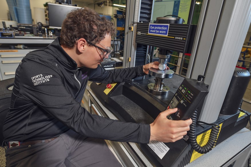 James Morris prepares a golf ball for the compression test.