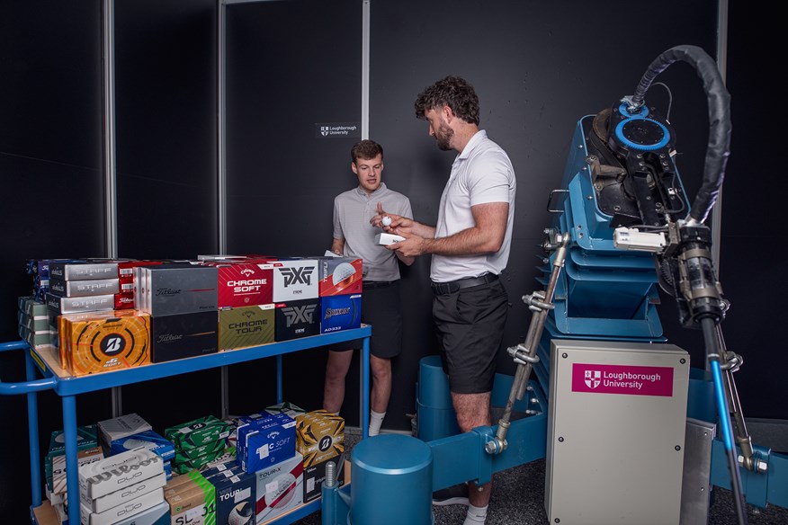Today's Golfer equipment editor Alex Lodge (right) and equipment writer James Hogg (right) discuss the golf balls being tested by the robot at Loughborough.