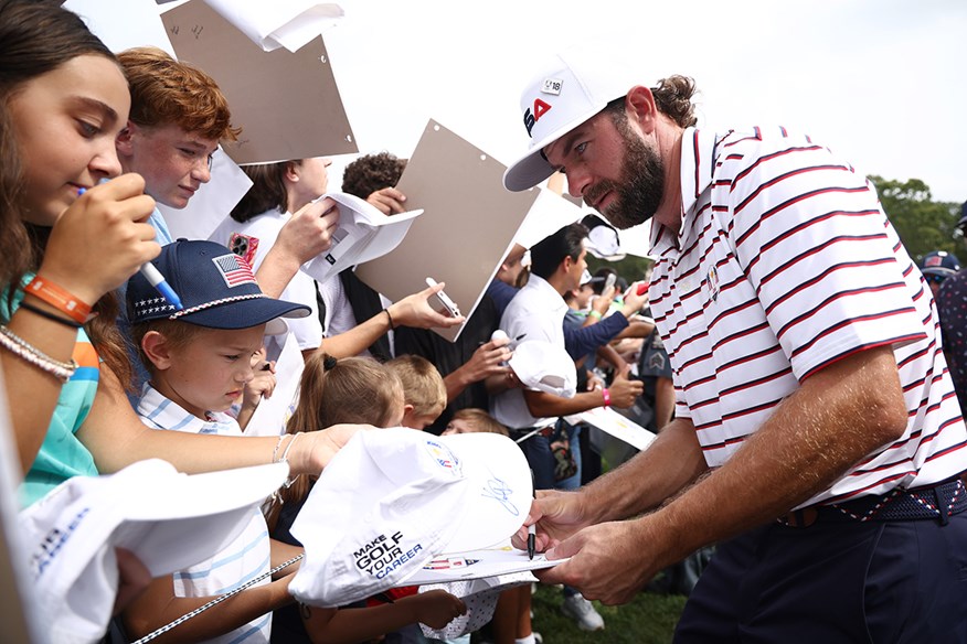 New Yorker Cameron Young signs autographs for his home fans at Bethpage.