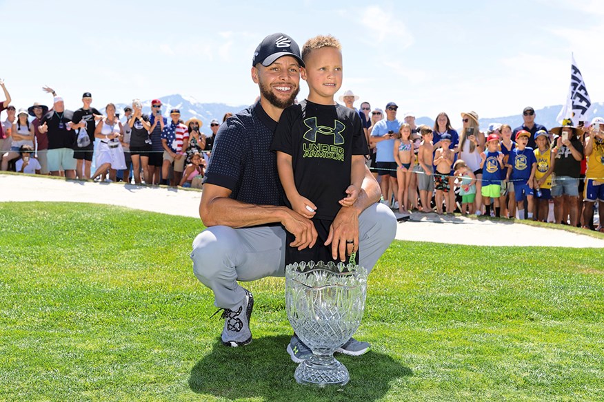 Steph Curry celebrating a victory at the 2023 American Century Championship with his son.