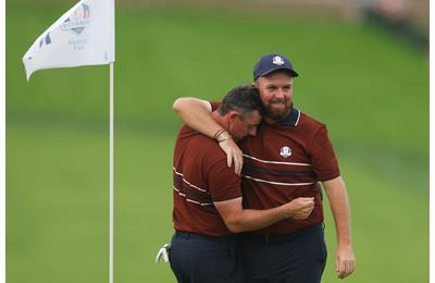 An exhausted Rory McIlroy and smiling Shane Lowry embrace after their Saturday fourballs win at the Ryder Cup.