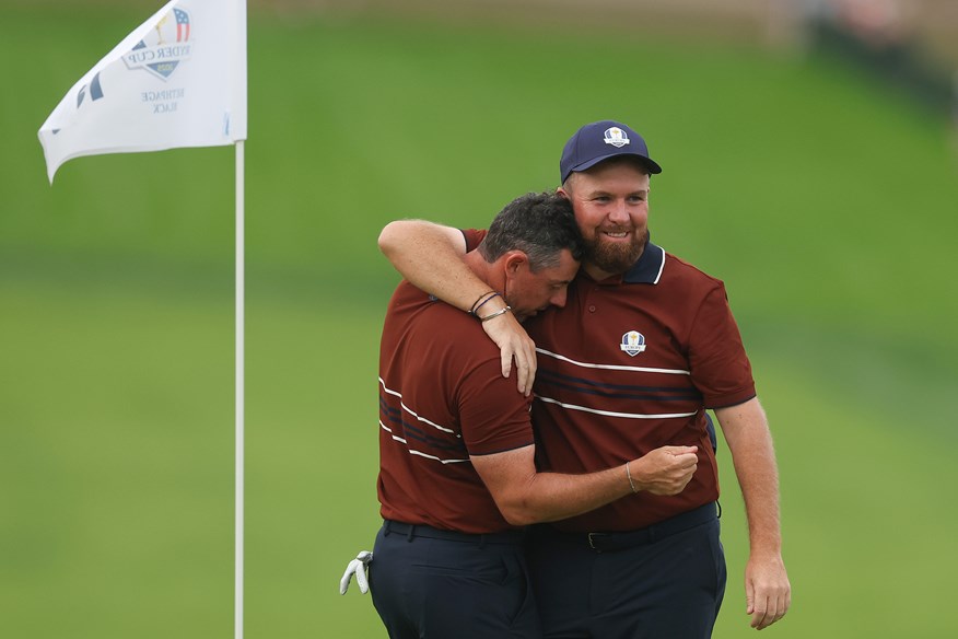 An exhausted Rory McIlroy and smiling Shane Lowry embrace after their Saturday fourballs win at the Ryder Cup.