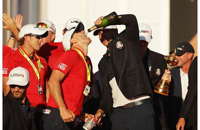 Brooks Koepka of the United States celebrates with a caddie during the closing ceremony