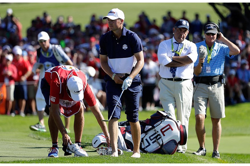 Jordan Spieth stands on the 17th green barefoot as he concedes his match to Henrik Stenson