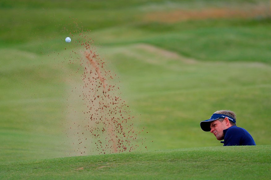 Luke Donald of England plays a shot from a bunker on the 4th at the 145th Open Championship at Royal Troon