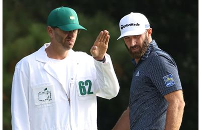 Austin Johnson uses AimPoint to check a putt for brother Dustin Johnson at the Masters.