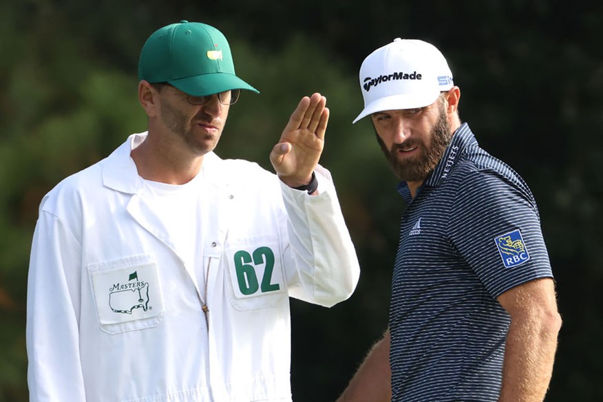 Austin Johnson uses AimPoint to check a putt for brother Dustin Johnson at the Masters.