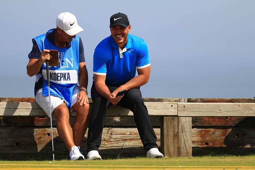 Brooks Koepka shares a joke with caddie Ricky Elliott at the 2019 Open.