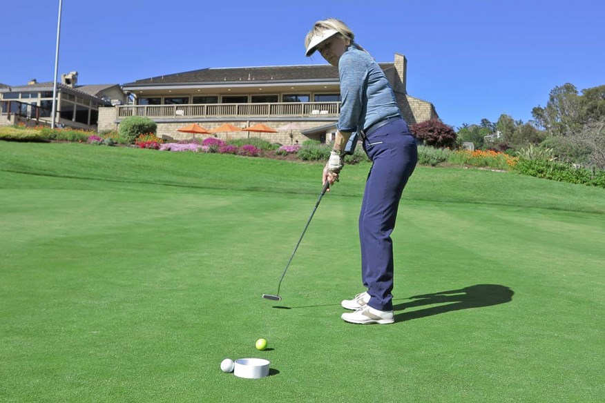 Golfers putting out to a raised cup due to Coronavirus