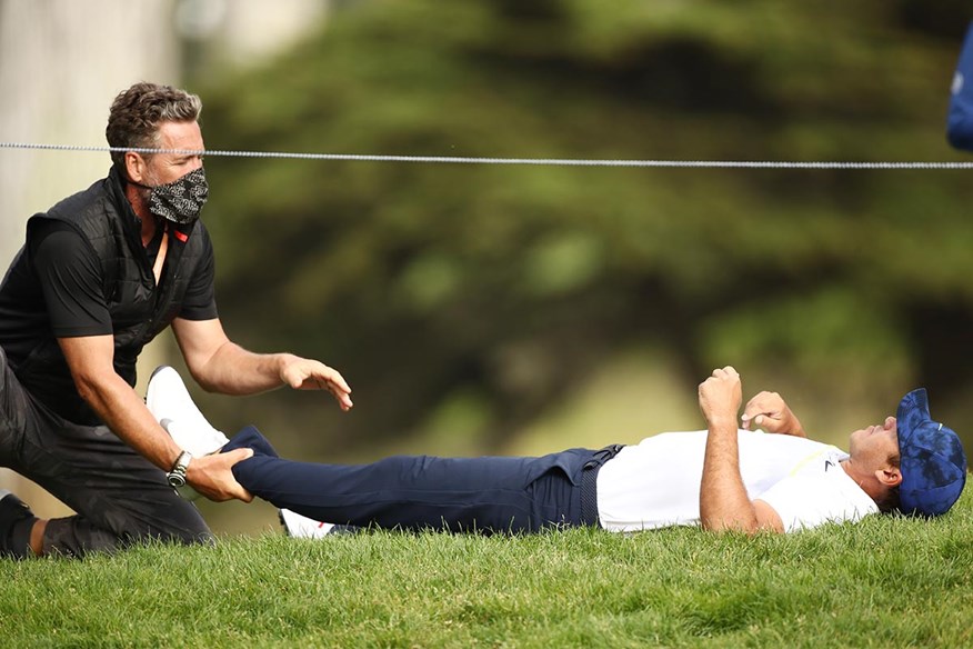 Brooks Koepka gets medical treatment on the 12th hole.