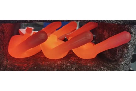 Six PXG irons being heated before being forged.