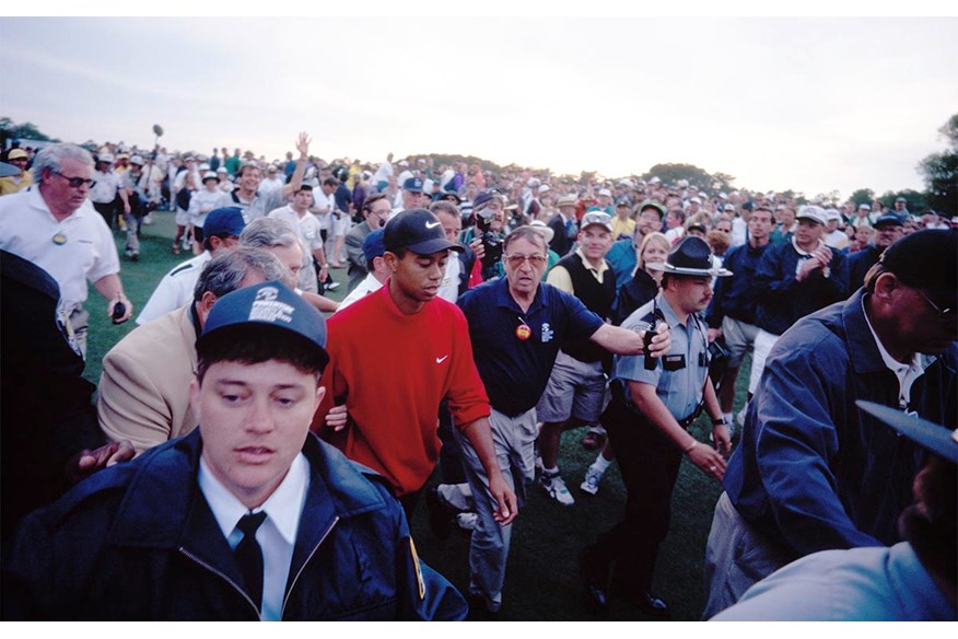 A taste of things to come as security help Tiger Woods through the huge Masters crowds.