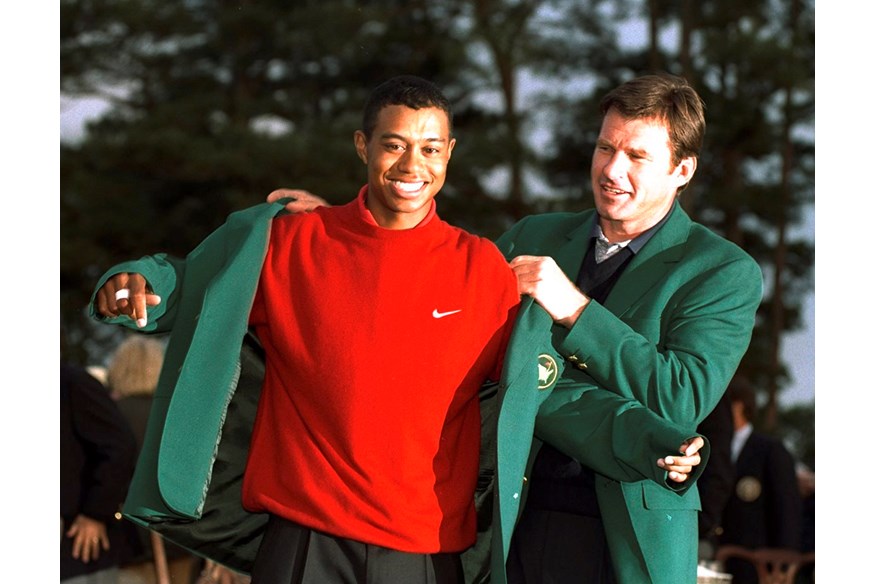 Nick Faldo helps Tiger Woods into his Green Jacket after his 1997 Masters win.