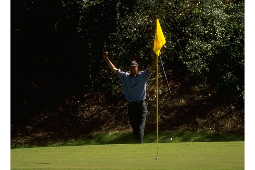 Tiger Woods celebrates holing a chip for birdie on the 12th hole of his opening round at the 1997 Masters.