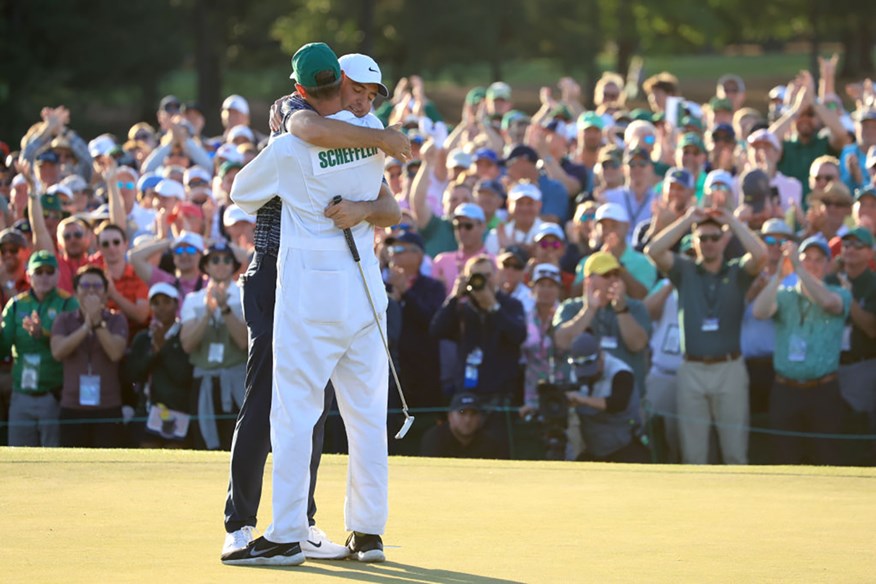 Scottie Scheffler celebrates winning The Masters with caddie Ted Scott.