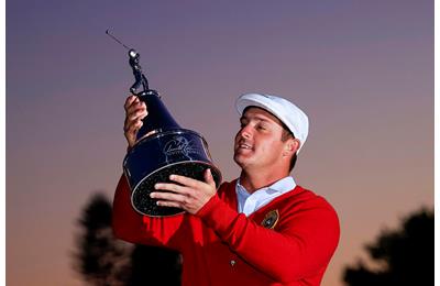 Bryson DeChambeau lifts the Arnold Palmer Invitational trophy.