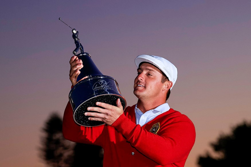 Bryson DeChambeau lifts the Arnold Palmer Invitational trophy.