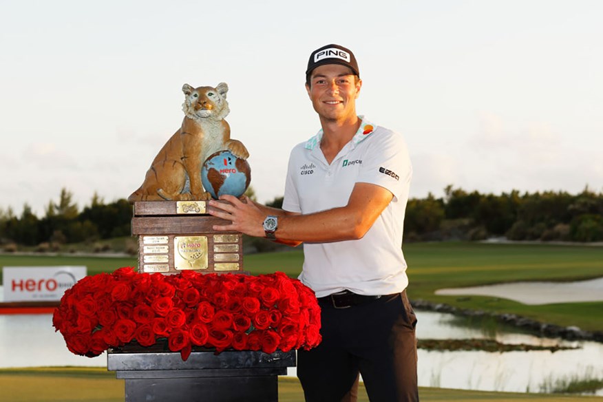 Viktor Hovland with the Hero World challenge trophy.