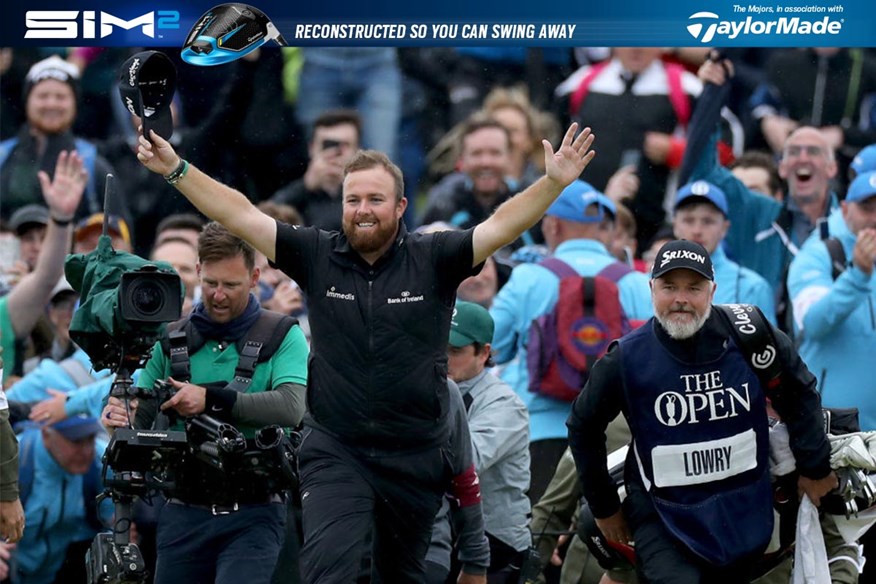 Shane Lowry celebrates winning The Open at Royal Portrush as he walks up the 18th fairway..