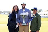 Tony Finau with his family holding the Houston Open trophy.