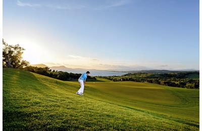 How to play a downhill golf chip shot.