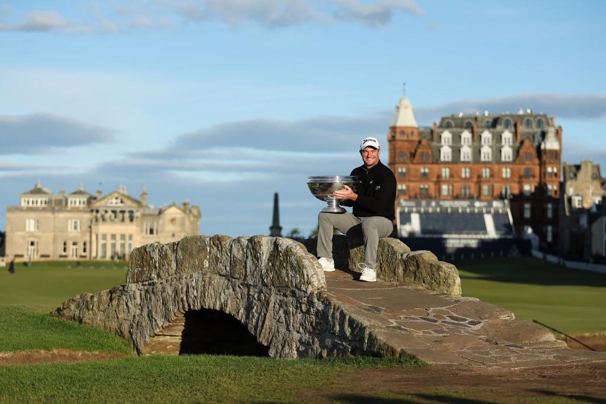 Ryan Fox sits on the Swilcan Bridge with the Dunhill Links trophy after his victory at St Andrews.