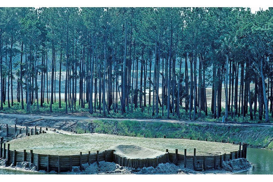 Water begins to fill the pit surrounding the 17th green.